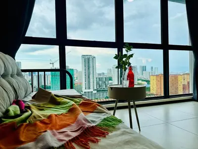 a bedroom with a view of a city from a window at Near komtar apartment in goergetown 3br 10 pax in George Town