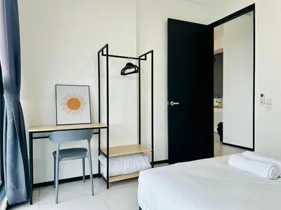 a bedroom with a desk and a chair next to a bed at Near komtar apartment in goergetown 3br 10 pax in George Town