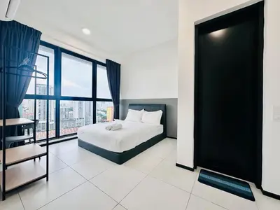 a bedroom with a bed and a large window at Near komtar apartment in goergetown 3br 10 pax in George Town