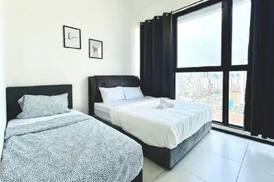 a bedroom with two beds and a window at Rooftop Penang View & infinity pool suite apartment 3br 10 pax in George Town