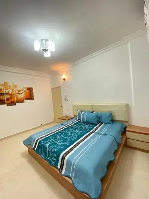 a large bed with blue sheets in a room at Wanie CH Homestay 1 Brinchang Cameron Highlands in Brinchang