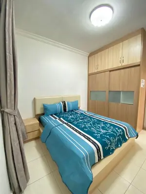 a bedroom with a large bed with blue sheets at Wanie CH Homestay 1 Brinchang Cameron Highlands in Brinchang