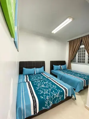 two beds sitting next to each other in a room at Wanie CH Homestay 1 Brinchang Cameron Highlands in Brinchang