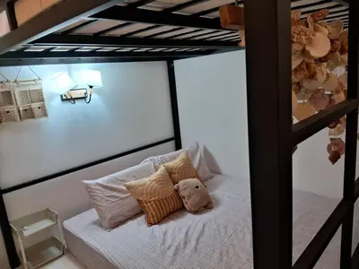 a bunk bed with a teddy bear sitting on it at HEE & PENNIE House in Ipoh