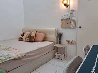 a bedroom with a bed with pillows on it at HEE & PENNIE House in Ipoh