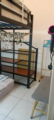 a room with a bunk bed and a chair at HEE & PENNIE House in Ipoh