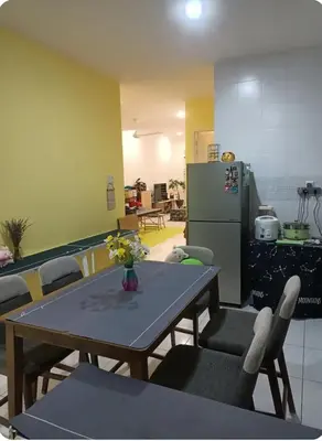 a kitchen with a table and chairs and a refrigerator at HEE & PENNIE House in Ipoh