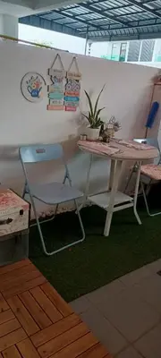 a table and a chair in a room with a table at HEE & PENNIE House in Ipoh