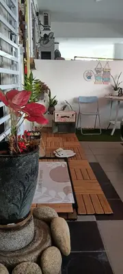 a room with a vase with a plant in it at HEE & PENNIE House in Ipoh