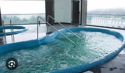 a jacuzzi tub in a building with a view at Belladira Homestay CH in Brinchang