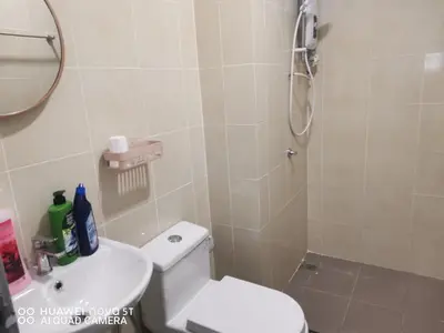 a bathroom with a shower and a toilet and a sink at Belladira Homestay CH in Brinchang