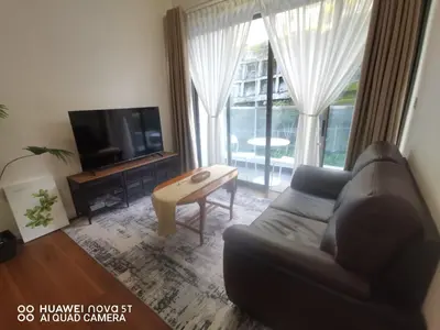 a living room with a couch and a tv and a table at Belladira Homestay CH in Brinchang
