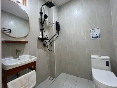 a bathroom with a sink and a mirror and a toilet at Hillview Ipoh in Ipoh