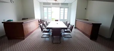 a dining room with a table and chairs and a window at Peking Hotel in George Town