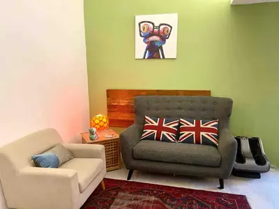 a living room with a couch and a chair at Ipoh Garden Canning Very Near Food Desire Homestay in Ipoh