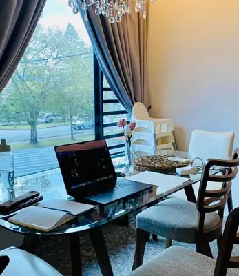 a laptop computer sitting on a table in a room with a window at Ipoh Garden Canning Very Near Food Desire Homestay in Ipoh