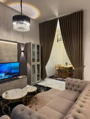 a living room with a couch and a tv at Zhara Homestay in Ipoh