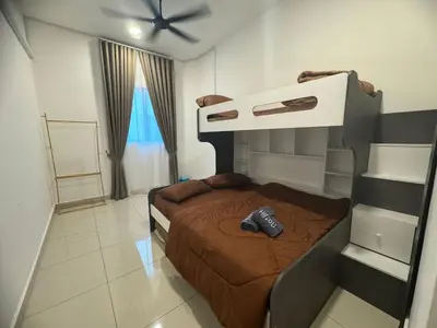 a bedroom with a bed with a remote control on it at Zhara Homestay in Ipoh
