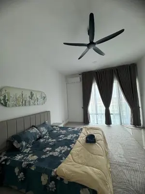 a bedroom with a bed and a ceiling fan at Zhara Homestay in Ipoh
