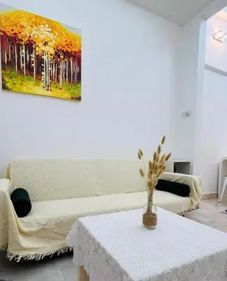 a living room with a table and a painting on the wall at Ipoh Garden 5 Homestay in Ipoh