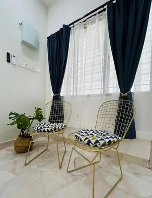 two chairs sitting in a room with a window at Ipoh Garden 5 Homestay in Ipoh