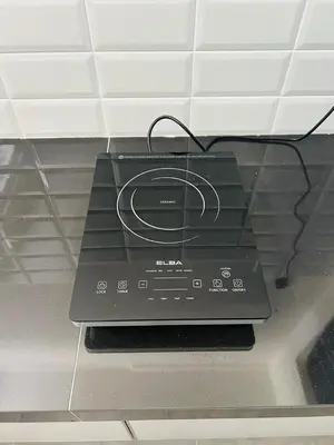 a black stove top oven with a wire on it at Ipoh Garden 5 Homestay in Ipoh