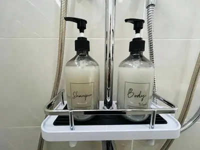 two bottles of soap sitting on a shelf in a bathroom at Ipoh Garden 5 Homestay in Ipoh