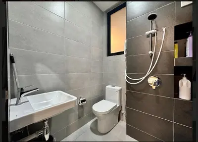 a bathroom with a toilet and a sink at Luxury suites UB 3br 10 pax in Jelutong