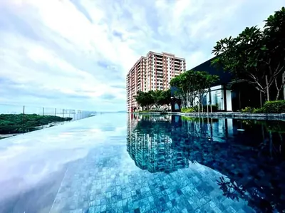 a large swimming pool with a building in the background at luxury familystay 3br 10 pax in Jelutong