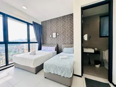 a bedroom with two beds and a sink in it at luxury familystay 3br 10 pax in Jelutong