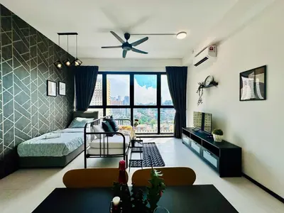 a bedroom with a bed and a ceiling fan at luxury familystay 3br 10 pax in Jelutong
