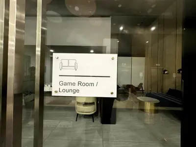 a sign that says game room and lounge on a window at luxury familystay 3br 10 pax in Jelutong