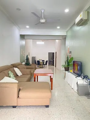 a living room with a couch and a table at 8 pax KakaHomestay Tmn Petani Jaya in Sungai Petani