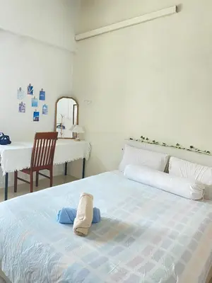 a bedroom with a bed with a towel on it at 8 pax KakaHomestay Tmn Petani Jaya in Sungai Petani