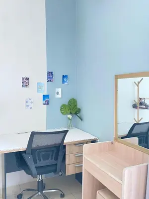 a blue room with a desk and a mirror at 8 pax KakaHomestay Tmn Petani Jaya in Sungai Petani