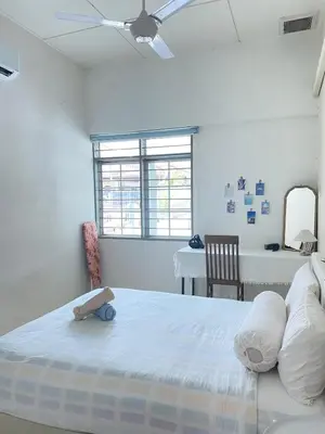 a white bedroom with a bed and a table at 8 pax KakaHomestay Tmn Petani Jaya in Sungai Petani