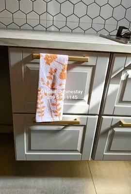a towel is hanging on the drawers of a kitchen counter at D Nabils Homestay Musslim Sahaja in Kulim