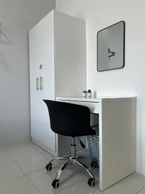 a white desk with a black chair in a room at Ipoh Cozy Stay Near Town & Park in Ipoh
