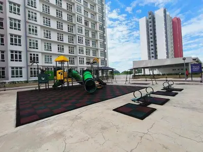 a playground in the middle of a city with buildings at Ipoh Cozy Stay Near Town & Park in Ipoh