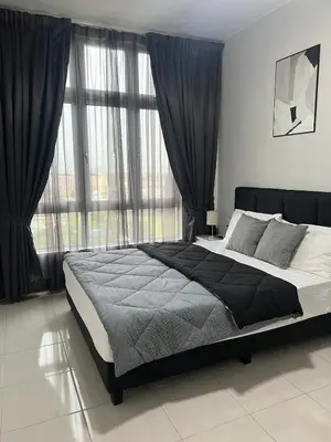a bedroom with a large bed in front of a window at Ipoh Cozy Stay Near Town & Park in Ipoh