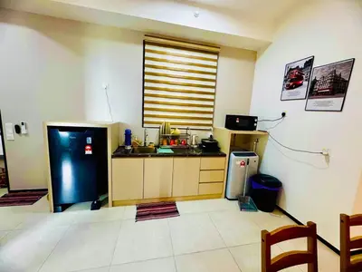a kitchen with a large refrigerator and a window at Stunning Luxury Breathtaking Sea & City Views 3BR 12PAX in Jelutong