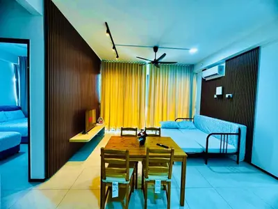 a living room with a table and a couch at Luxury Sea & City Views 3BR 12PAX in Jelutong