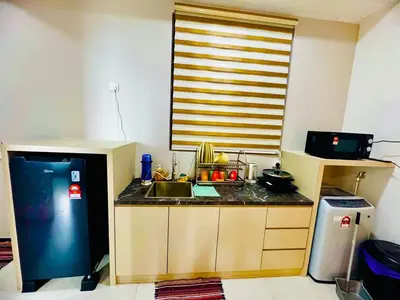 a small kitchen with a sink and a refrigerator at Luxury Sea & City Views 3BR 12PAX in Jelutong