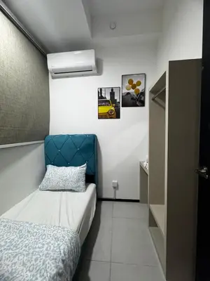 a bedroom with a bed and a blue headboard at Luxury Sea & City Views 3BR 12PAX in Jelutong