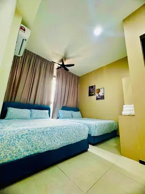 a bedroom with two beds and a ceiling fan at Luxury Sea & City Views 3BR 12PAX in Jelutong
