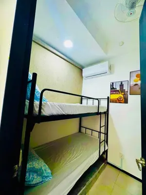 two bunk beds in a room with a ceiling at Luxury Sea & City Views 3BR 12PAX in Jelutong