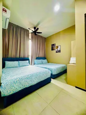 a bedroom with two beds and a ceiling fan at Luxury Sea & City Views 3BR 12PAX in Jelutong