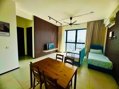 a living room with a table and a dining room at Cozy with Sea & City Views 3BR 12PAX in Jelutong