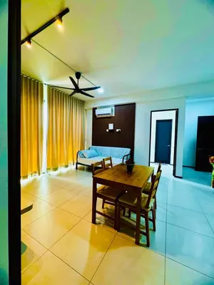 a living room with a table and a bed at Cozy with Sea & City Views 3BR 12PAX in Jelutong