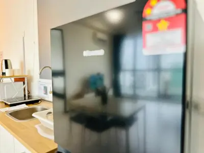 a blurry picture of a kitchen with a refrigerator at Luxury Suites with Sea & City Views 3BR 12PAX in Jelutong